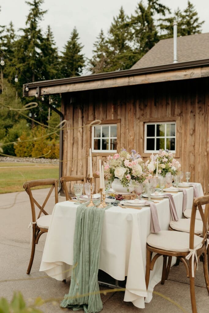 Romantic outdoor wedding reception at Hillside Farms barn wedding venue in Olympia Washington with string lights and sweetheart table